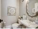 Stylish powder room with ornate mirror and decorative wall art at 5341 Hill Nw Rd, Acworth, GA 30101