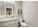 Elegant powder room with granite vanity, ornate mirror, and decorative wall art at 5341 Hill Nw Rd, Acworth, GA 30101