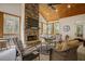 Cozy screened porch with stone fireplace, wicker furniture, and wood ceiling at 5341 Hill Nw Rd, Acworth, GA 30101