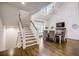 Modern white staircase with wood accents leading to the second floor at 5341 Hill Nw Rd, Acworth, GA 30101