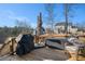 Expansive wooden deck with grill and seating, offering scenic views of the surrounding treed landscape at 514 Perdue Trl, Canton, GA 30115