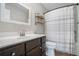 Well-lit bathroom with modern vanity, framed mirror, and a shower-tub combo with a stylish curtain at 514 Perdue Trl, Canton, GA 30115