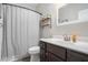 Cozy bathroom featuring a dark vanity, white sink, and convenient storage shelves at 514 Perdue Trl, Canton, GA 30115
