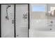 Bright bathroom with a glass-enclosed shower, soaking tub, and a window for natural light at 514 Perdue Trl, Canton, GA 30115