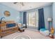 Nautical-themed Bedroom with blue walls, a charming crib, and playful maritime decor at 514 Perdue Trl, Canton, GA 30115