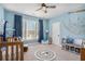 Nautical-themed Bedroom with blue walls, a charming crib, and playful maritime decor at 514 Perdue Trl, Canton, GA 30115