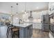 Bright kitchen features a gray island, stainless appliances, pendant lighting, and an eat-in dining area at 514 Perdue Trl, Canton, GA 30115