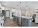 Kitchen boasts stainless appliances, a gray island, and an open floor plan leading to a cozy living space at 514 Perdue Trl, Canton, GA 30115