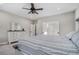 Bright main bedroom featuring a ceiling fan, ensuite bathroom, and and dressers at 514 Perdue Trl, Canton, GA 30115