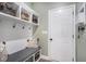 Charming mudroom featuring a bench with storage, hooks, and decorative shelving for organization at 514 Perdue Trl, Canton, GA 30115