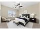Staged bedroom featuring a ceiling fan, neutral decor, and natural light from the window at 1251 Irwin Lake Way, Marietta, GA 30064