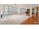 Gathering room with a fireplace, hardwood floors, and many windows at 1251 Irwin Lake Way, Marietta, GA 30064