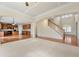 Gathering room with hardwood and carpeted floors, kitchen view, and fireplace at 1251 Irwin Lake Way, Marietta, GA 30064