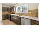 Kitchen with dark brown cabinets, granite counters and stainless steel appliances at 1251 Irwin Lake Way, Marietta, GA 30064