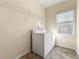 Bright laundry room with washer, dryer, and overhead shelving at 1251 Irwin Lake Way, Marietta, GA 30064