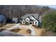 Luxury home with detached garage and circular driveway nestled in the woods at 5152 Boulder Bluff Way, Suwanee, GA 30024