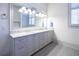 Double vanity bathroom with granite countertop and large mirror at 5152 Boulder Bluff Way, Suwanee, GA 30024