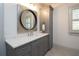 Bathroom with gray vanity, quartz countertop, and a large mirror at 5152 Boulder Bluff Way, Suwanee, GA 30024
