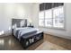 Comfortable bedroom with hardwood floors and large windows with shutters at 5152 Boulder Bluff Way, Suwanee, GA 30024