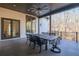 Spacious covered patio with outdoor dining furniture, offering wooded views at 5152 Boulder Bluff Way, Suwanee, GA 30024