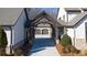 Covered driveway entrance with a wooden pergola structure at 5152 Boulder Bluff Way, Suwanee, GA 30024