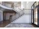 Elegant two-story entryway with curved staircase and hardwood floors at 5152 Boulder Bluff Way, Suwanee, GA 30024