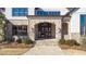 Elegant entryway with stone arch, double doors, and stone steps at 5152 Boulder Bluff Way, Suwanee, GA 30024