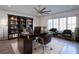 Home office with built-in bookshelves, large desk, and comfortable seating at 5152 Boulder Bluff Way, Suwanee, GA 30024