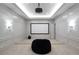 Home theater room with projector, screen, and comfortable seating at 5152 Boulder Bluff Way, Suwanee, GA 30024