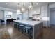 Open kitchen with large island, breakfast bar, and high-end finishes at 5152 Boulder Bluff Way, Suwanee, GA 30024
