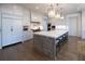 Modern kitchen features a large island with seating, stainless steel appliances, and white cabinets at 5152 Boulder Bluff Way, Suwanee, GA 30024