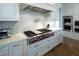 Luxury kitchen with high-end stainless steel range, white cabinetry, and quartz countertops at 5152 Boulder Bluff Way, Suwanee, GA 30024