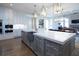 Gourmet kitchen boasts expansive island, stainless steel appliances, and white cabinetry at 5152 Boulder Bluff Way, Suwanee, GA 30024