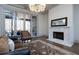 Living room with fireplace, hardwood floors, and access to patio at 5152 Boulder Bluff Way, Suwanee, GA 30024
