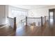Bright upper hallway with hardwood floors, white railings, and natural light at 5152 Boulder Bluff Way, Suwanee, GA 30024