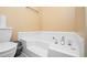 Bright bathroom featuring a built-in tub and toilet, with modern fixtures at 4211 Wingfoot Ct, Decatur, GA 30035