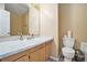 Bathroom with a marble countertop and wood vanity. The toilet sits next to a garbage can at 4211 Wingfoot Ct, Decatur, GA 30035