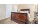 Bedroom with neutral walls, carpet floors, and a sleigh bed with white bedding at 4211 Wingfoot Ct, Decatur, GA 30035