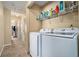 Convenient laundry area with washer, dryer, and shelving for supplies at 4211 Wingfoot Ct, Decatur, GA 30035