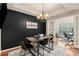 Elegant dining room with a dark accent wall and chandelier at 1250 Parkwood Se Cir # 2314, Atlanta, GA 30339