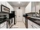 Modern kitchen with white cabinets, black countertops, and stainless steel appliances at 1250 Parkwood Se Cir # 2314, Atlanta, GA 30339