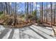 Stone wall borders a long driveway leading to the home at 210 Bluff Creek Dr, Woodstock, GA 30188