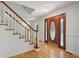 Bright entryway with hardwood floors and elegant staircase at 210 Bluff Creek Dr, Woodstock, GA 30188