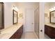 Bathroom showcasing a dual vanity, large mirror, and glass shower with seat at 351 Washington Ne Ave # 208, Marietta, GA 30060