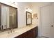 Bathroom featuring double sinks, vanity, sconces, and a framed mirror above at 351 Washington Ne Ave # 208, Marietta, GA 30060