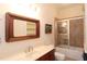 Bathroom with a wooden vanity, framed mirror, and tub/shower combo at 351 Washington Ne Ave # 208, Marietta, GA 30060