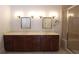 Bathroom featuring a double vanity with dark wood cabinets and framed mirrors at 351 Washington Ne Ave # 208, Marietta, GA 30060
