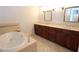 Bright bathroom featuring a bathtub and double vanity with dark wood cabinets at 351 Washington Ne Ave # 208, Marietta, GA 30060