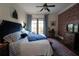 Main bedroom with king-size bed, brick accent wall, and access to balcony at 351 Washington Ne Ave # 208, Marietta, GA 30060