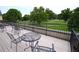 Outdoor deck with metal table and chairs overlooking a cemetery at 351 Washington Ne Ave # 208, Marietta, GA 30060